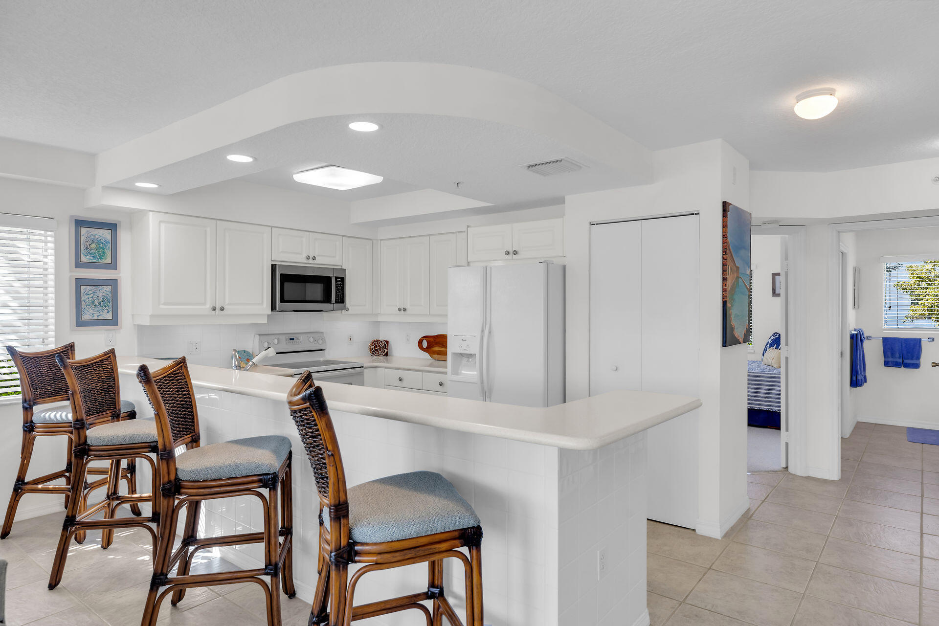 95 Coco Plum Drive, Unit 5A Marathon, FL 33050 - Photo 11 of 34 a kitchen with stainless steel appliances kitchen island granite countertop a refrigerator and microwave
