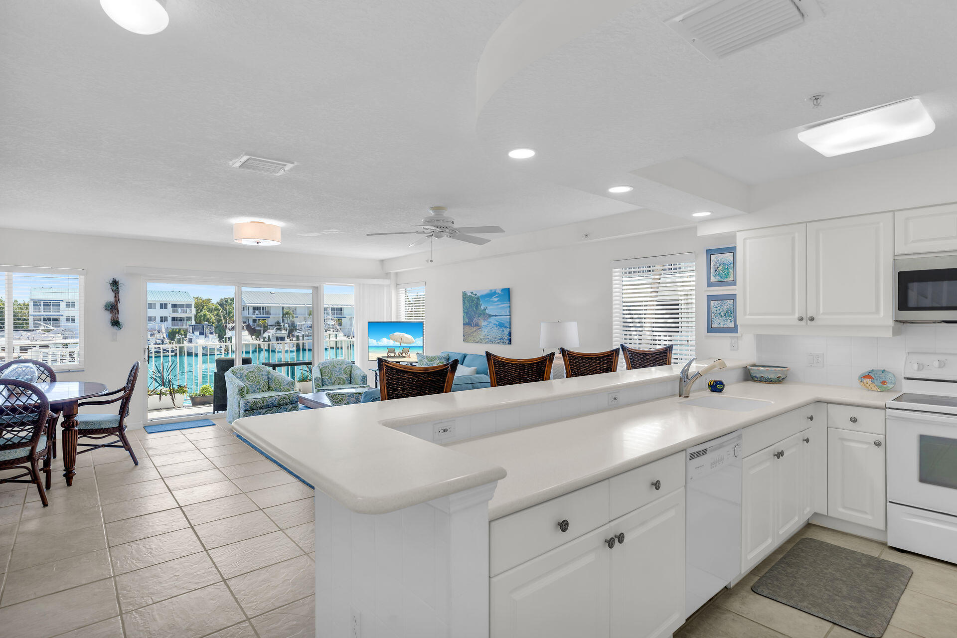 95 Coco Plum Drive, Unit 5A Marathon, FL 33050 - Photo 12 of 34 a large white kitchen with a large window