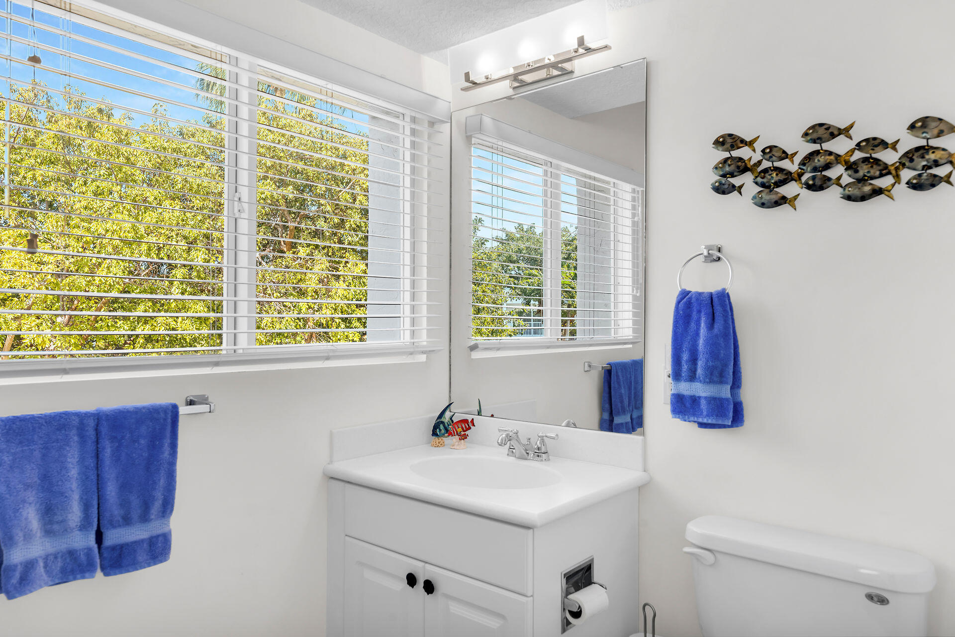 95 Coco Plum Drive, Unit 5A Marathon, FL 33050 - Photo 16 of 34 a bathroom with a sink and a mirror
