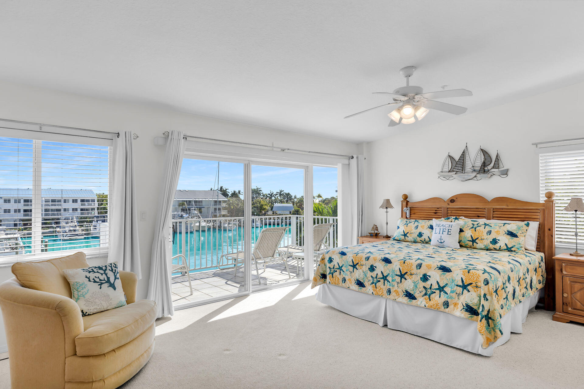 95 Coco Plum Drive, Unit 5A Marathon, FL 33050 - Photo 17 of 34 a bedroom with a bed couch and a large window with garden view