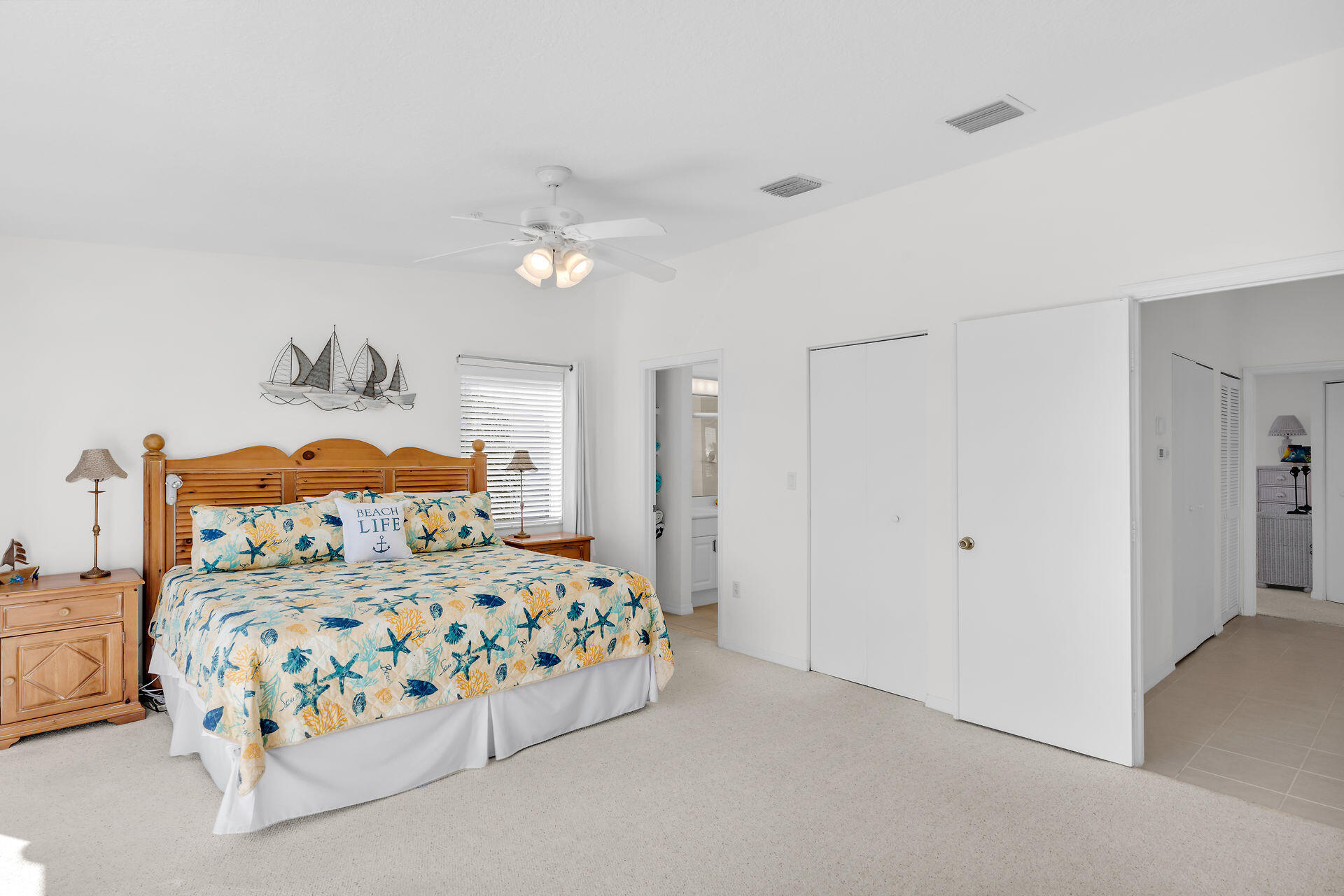 95 Coco Plum Drive, Unit 5A Marathon, FL 33050 - Photo 18 of 34 a bedroom with a bed and a chandelier