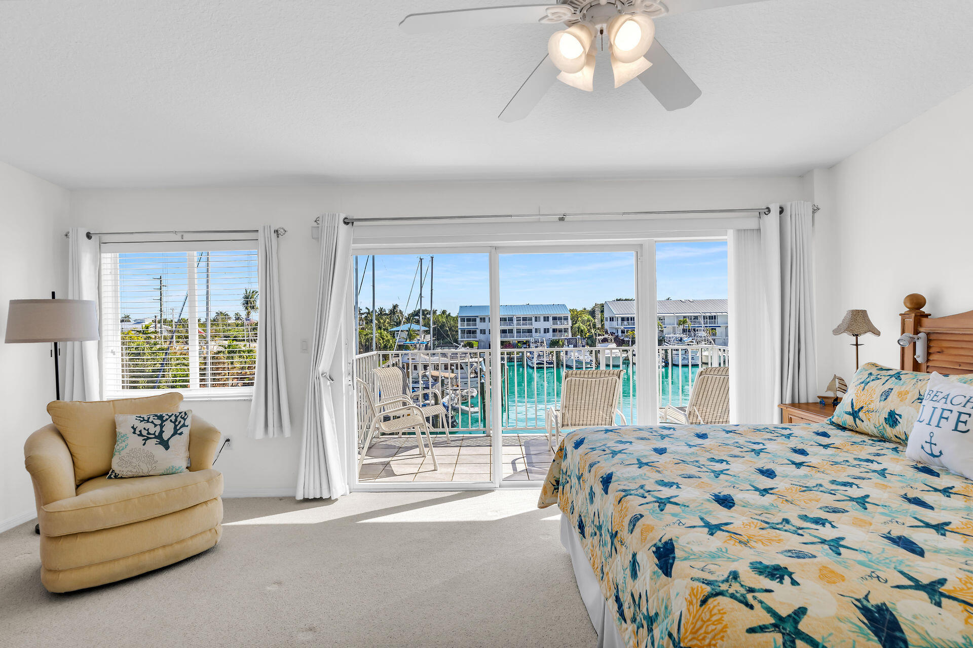 95 Coco Plum Drive, Unit 5A Marathon, FL 33050 - Photo 19 of 34 a bedroom with a bed and a large window with the outer view