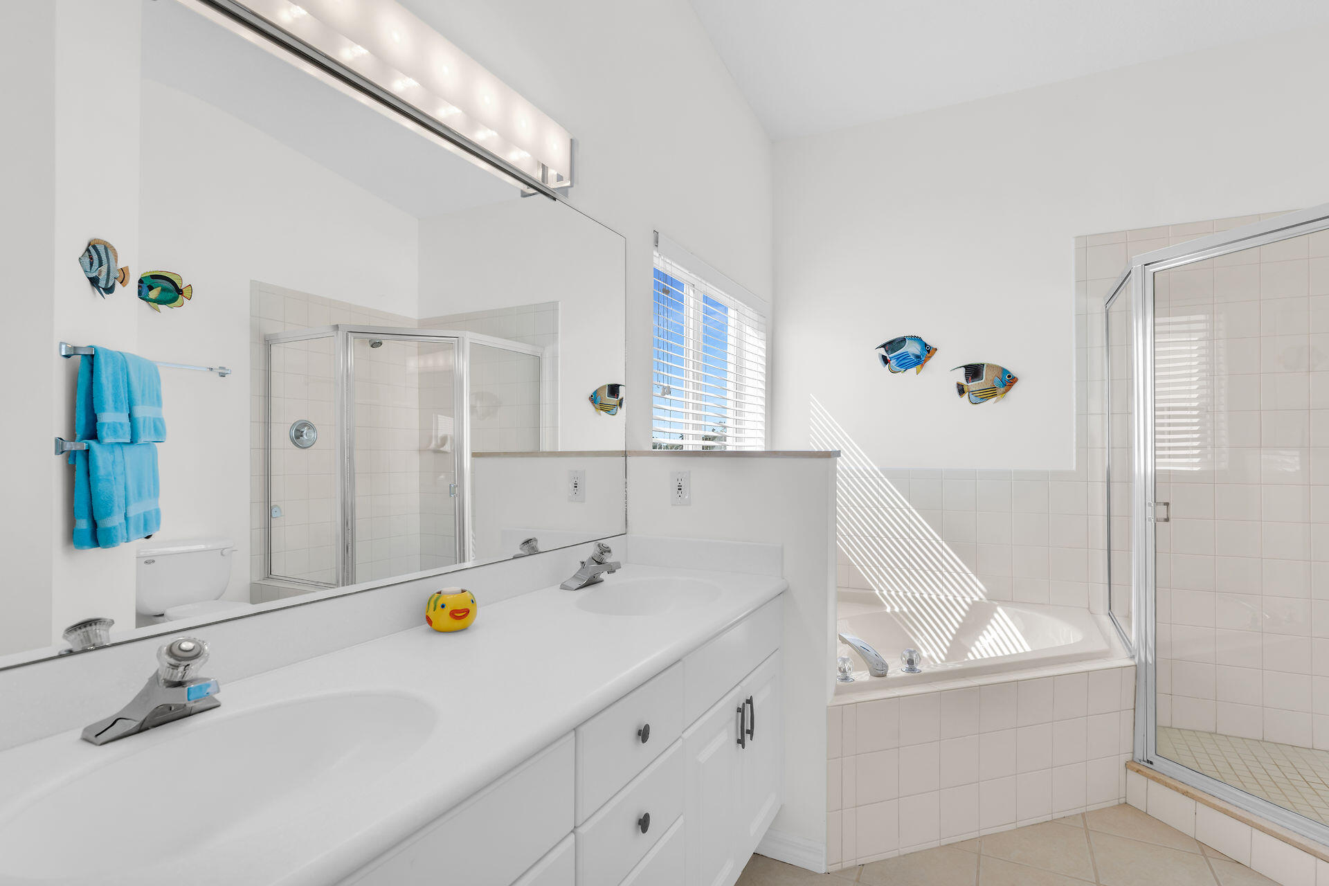 95 Coco Plum Drive, Unit 5A Marathon, FL 33050 - Photo 22 of 34 a bathroom with a tub sink and mirror