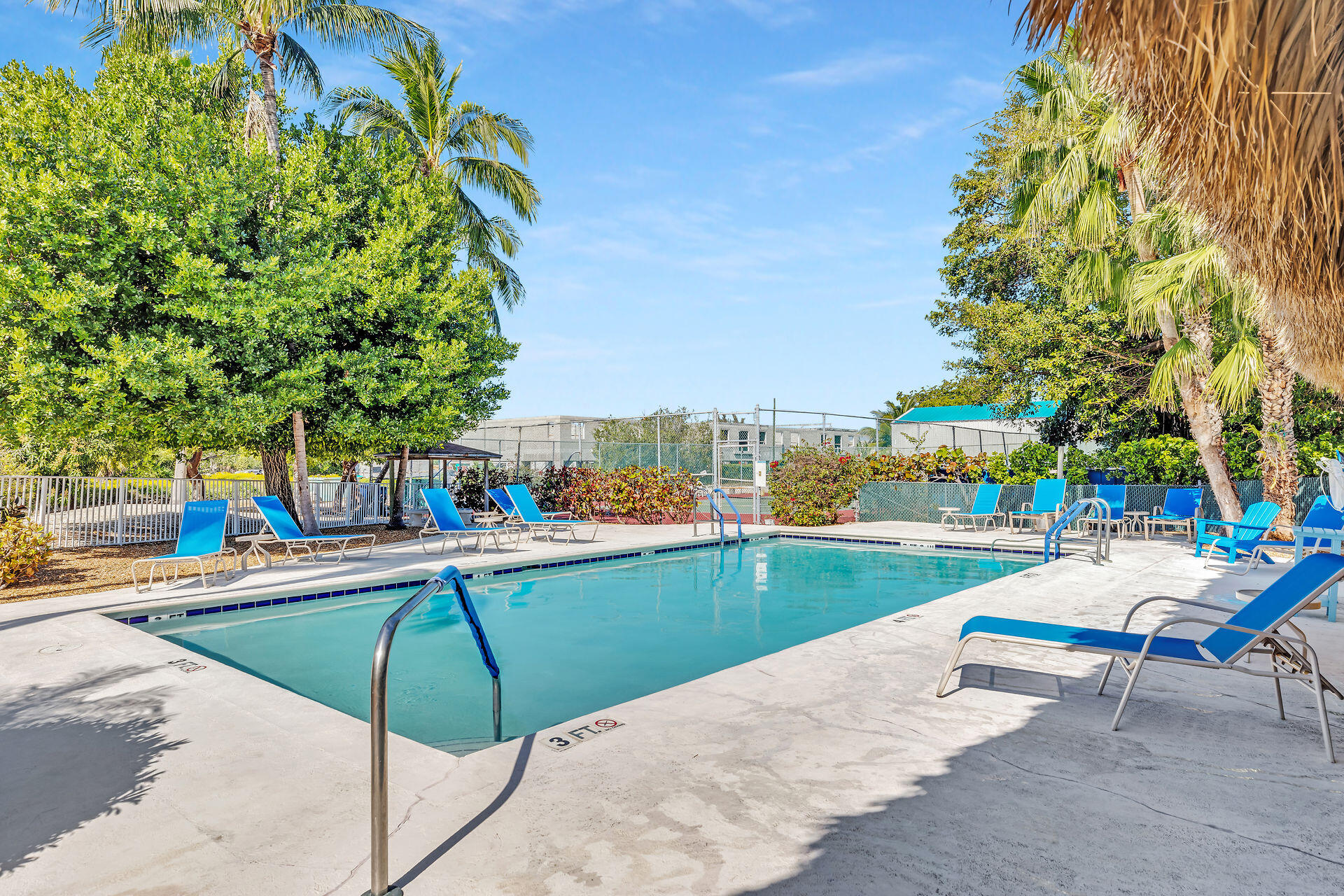 95 Coco Plum Drive, Unit 5A Marathon, FL 33050 - Photo 31 of 34 a view of a swimming pool with a lounge chairs
