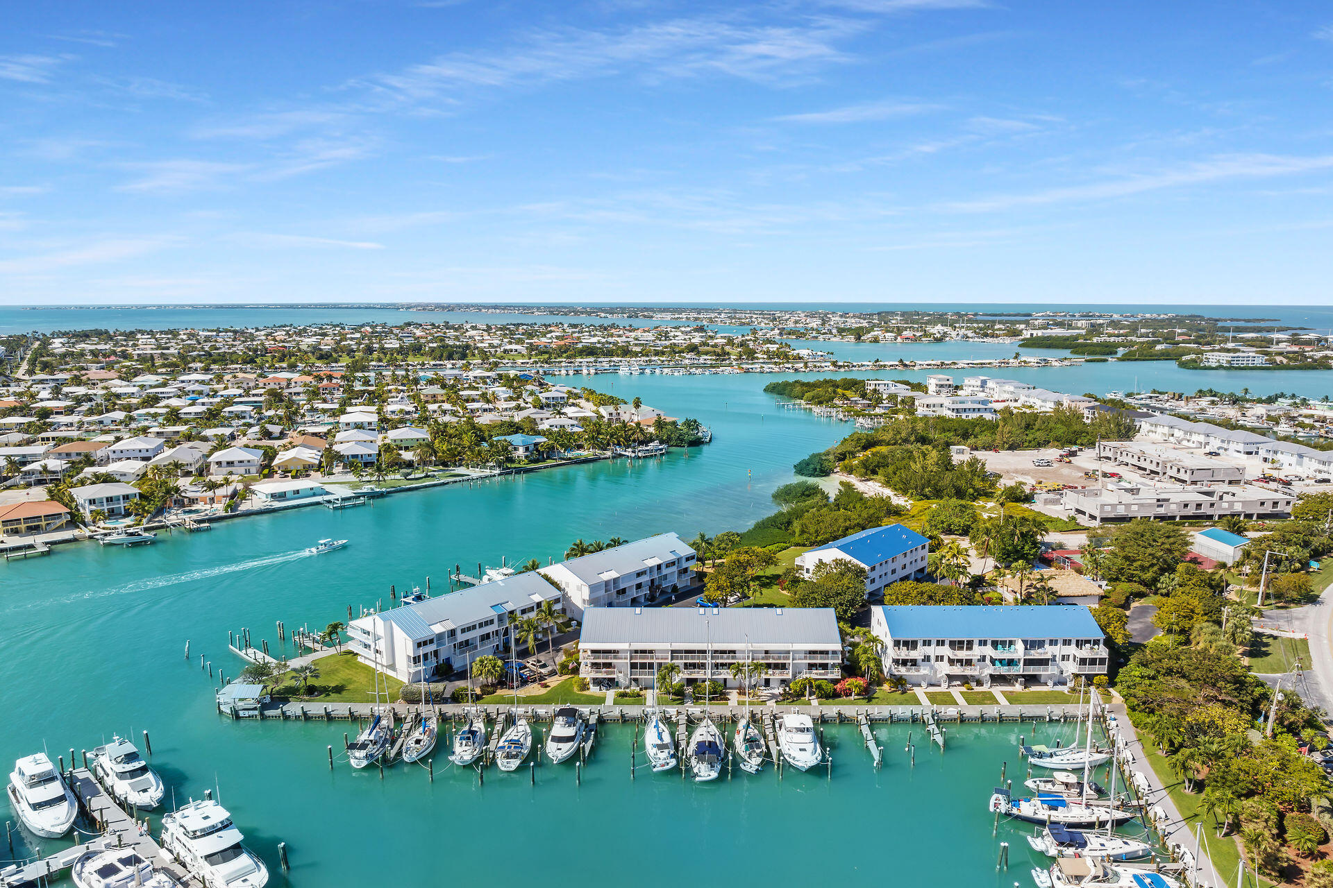 95 Coco Plum Drive, Unit 5A Marathon, FL 33050 - Photo 5 of 34 an aerial view of water body with boats and residential houses with outdoor space