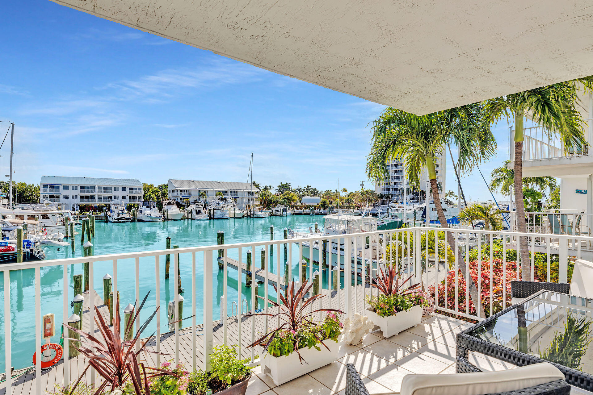 95 Coco Plum Drive, Unit 5A Marathon, FL 33050 - Photo 10 of 34 a view of a chairs and table in patio with a lake view