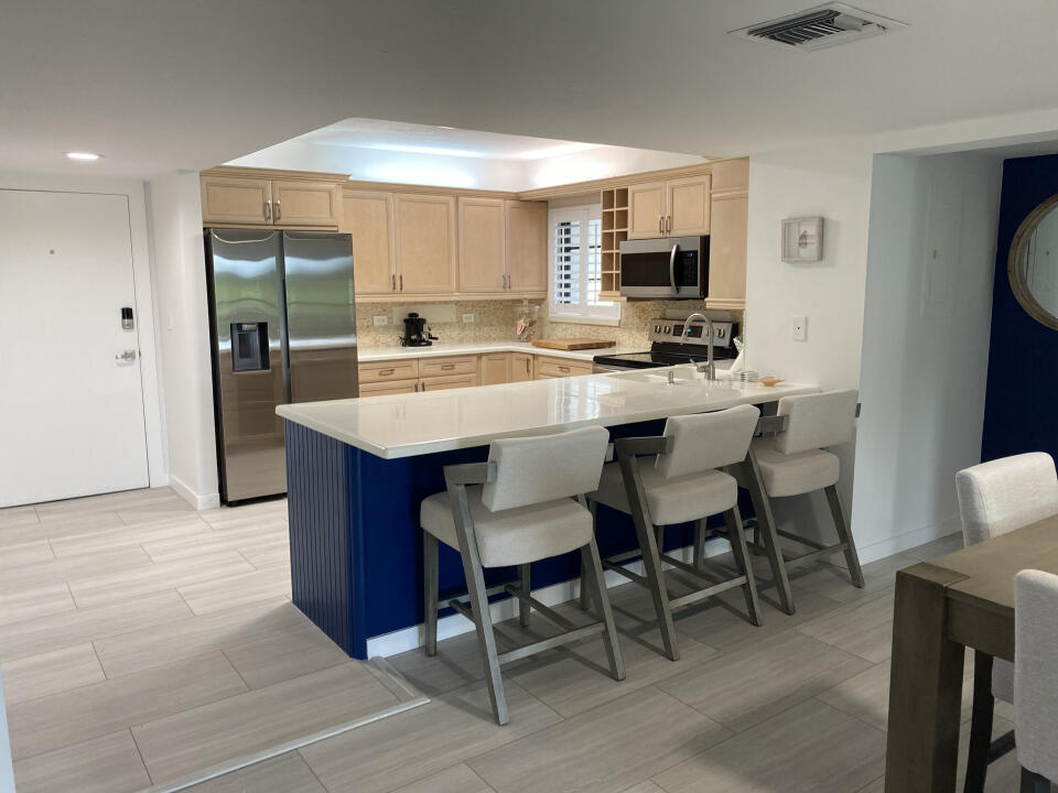 a view of kitchen with cabinets counter top space and stainless steel appliances