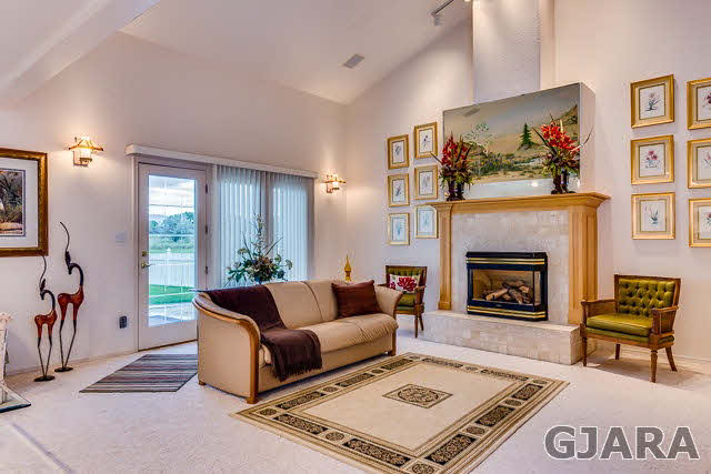 810 25 Road Grand Junction, CO 81505 - Photo 8 of 9 a living room with furniture and a fireplace