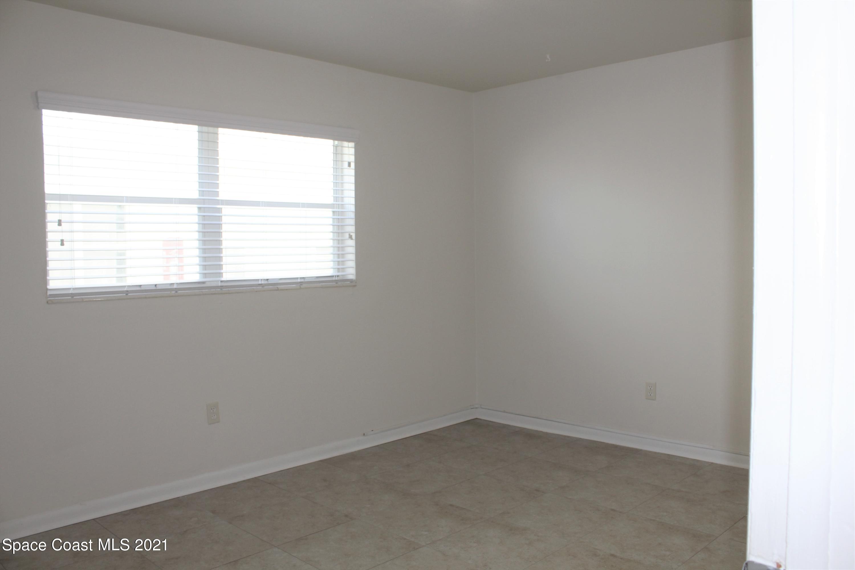 651 Palm Drive, Unit E1 Satellite Beach, FL 32937 - Photo 12 of 18 an empty room with a window