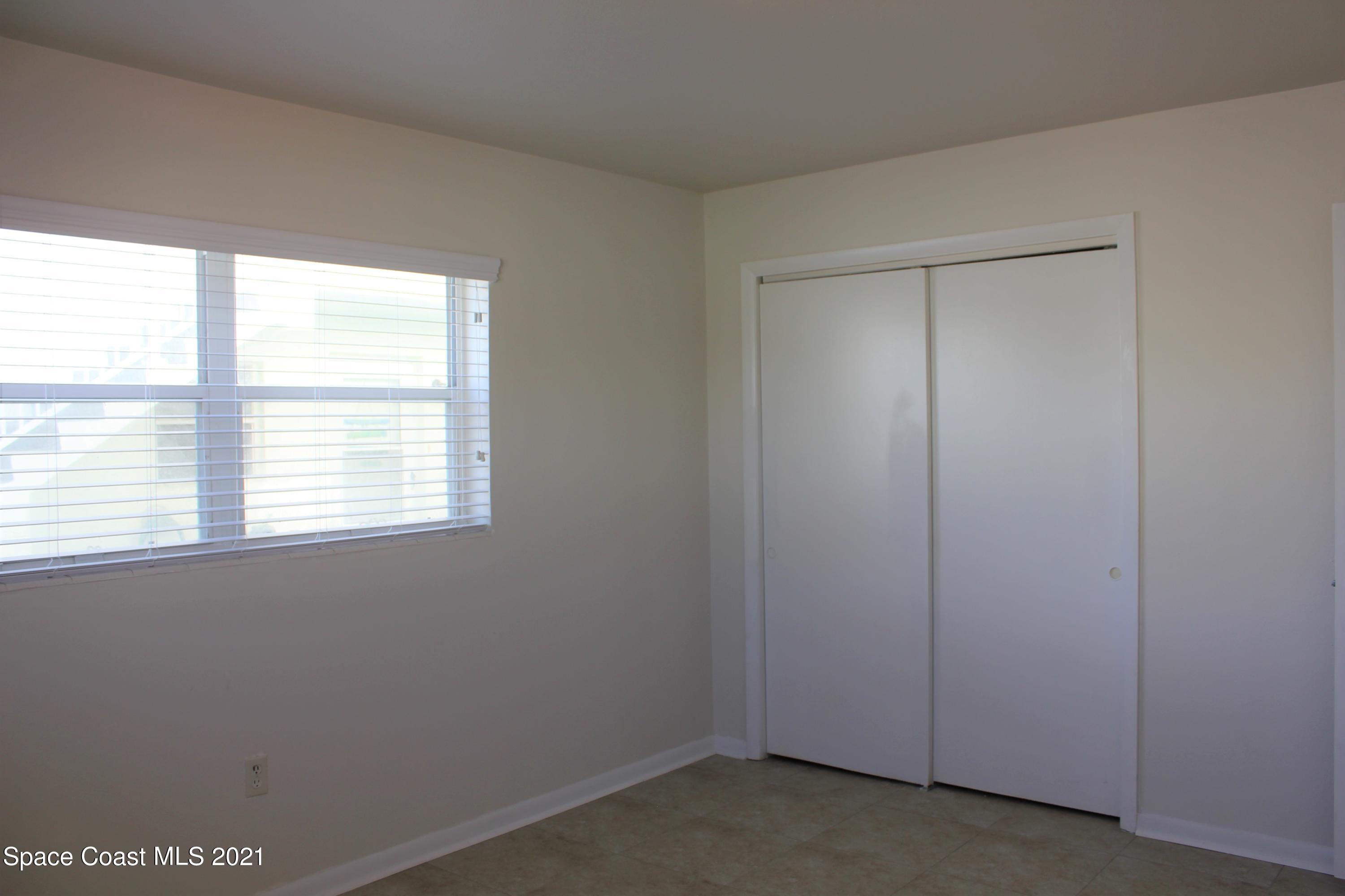 651 Palm Drive, Unit E1 Satellite Beach, FL 32937 - Photo 13 of 18 an empty room with a window