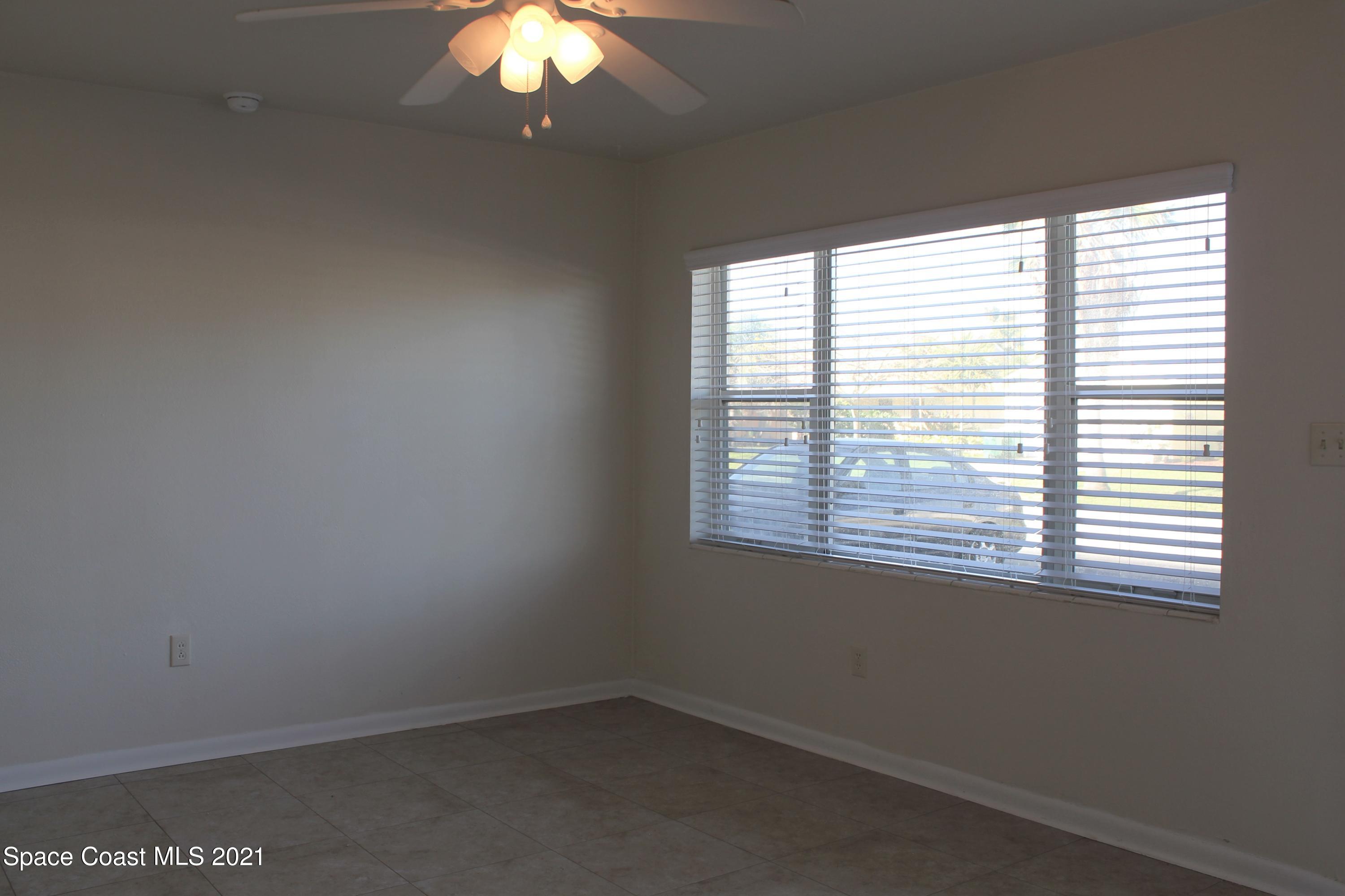 651 Palm Drive, Unit E1 Satellite Beach, FL 32937 - Photo 6 of 18 an empty room with a window