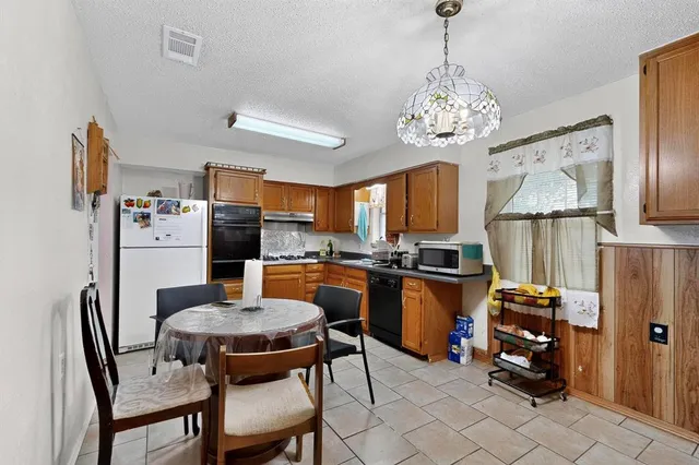 a view of a dining room with furniture and a chandelier