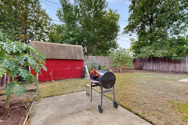 a backyard of a house with table and chairs