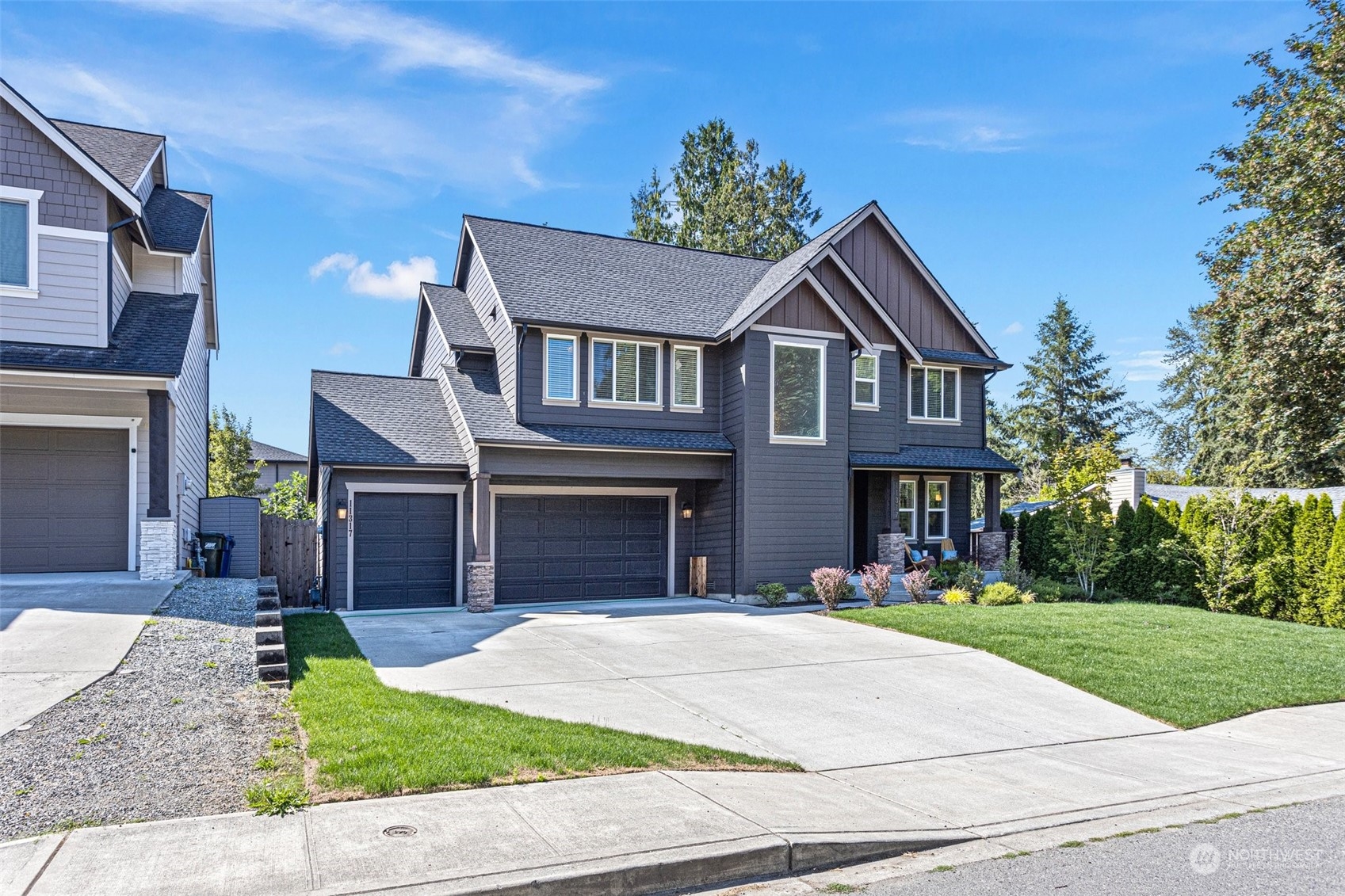 11317 Southeast 162nd Street Renton, WA 98055 - Photo 2 of 33 a front view of a house with a yard and garage