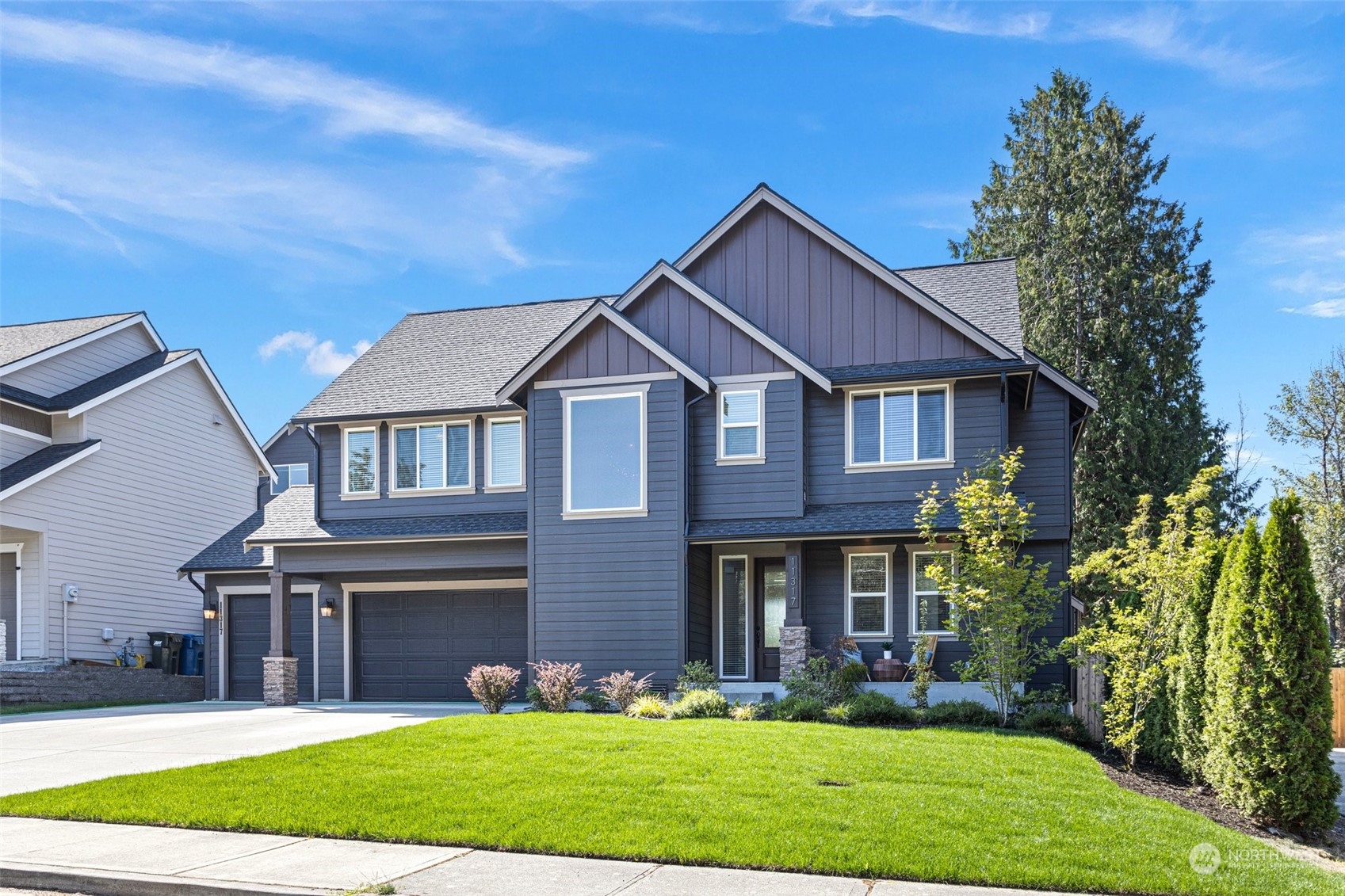 11317 Southeast 162nd Street Renton, WA 98055 - Photo 3 of 33 a front view of a house with garden