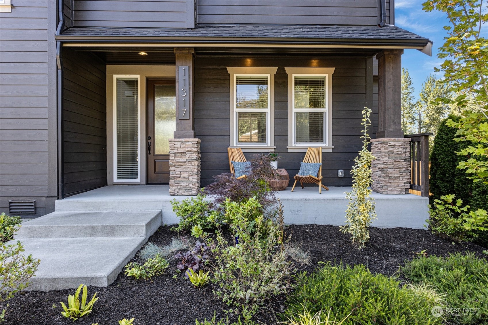11317 Southeast 162nd Street Renton, WA 98055 - Photo 4 of 33 a front view of a house with garden