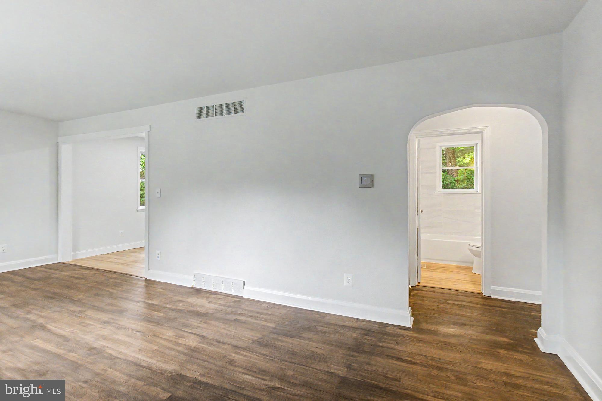 604 Prospect Mill Road Bel Air, MD 21015 - Photo 3 of 36 a view of an empty room with wooden floor and a window