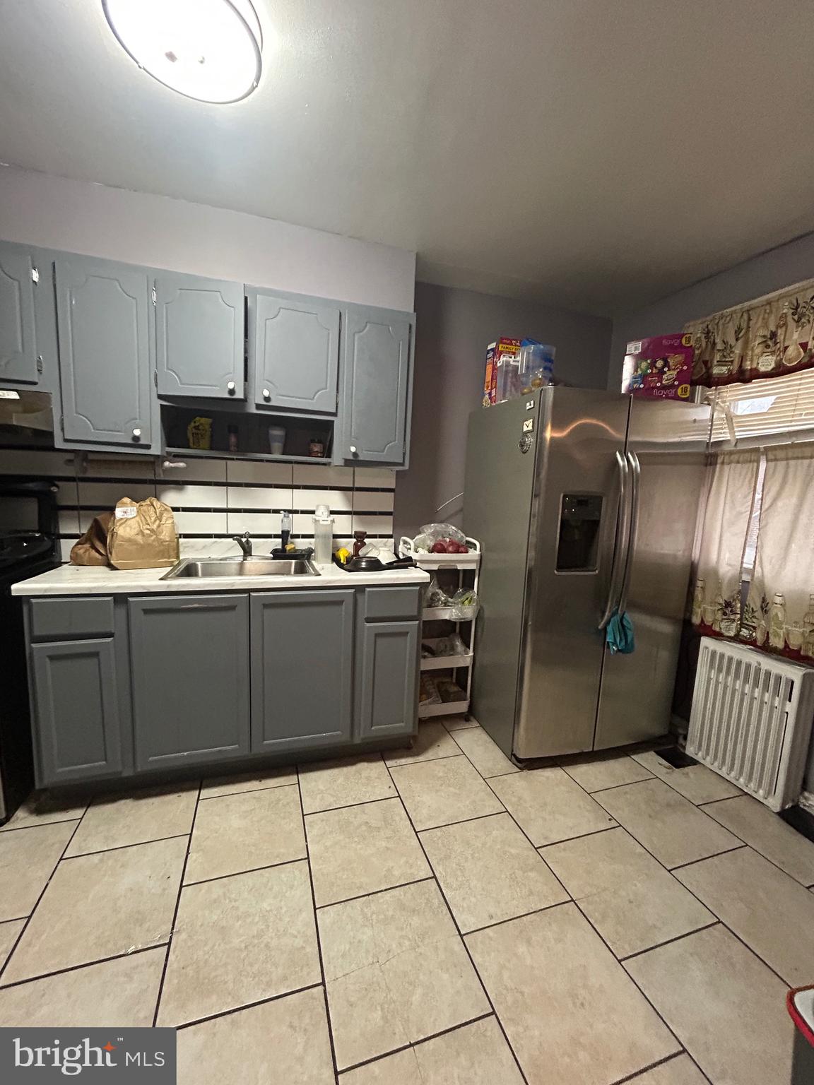 5331 Tabor Avenue Philadelphia, PA 19120 - Photo 13 of 18 a kitchen with stainless steel appliances granite countertop a sink a stove a microwave and a refrigerator