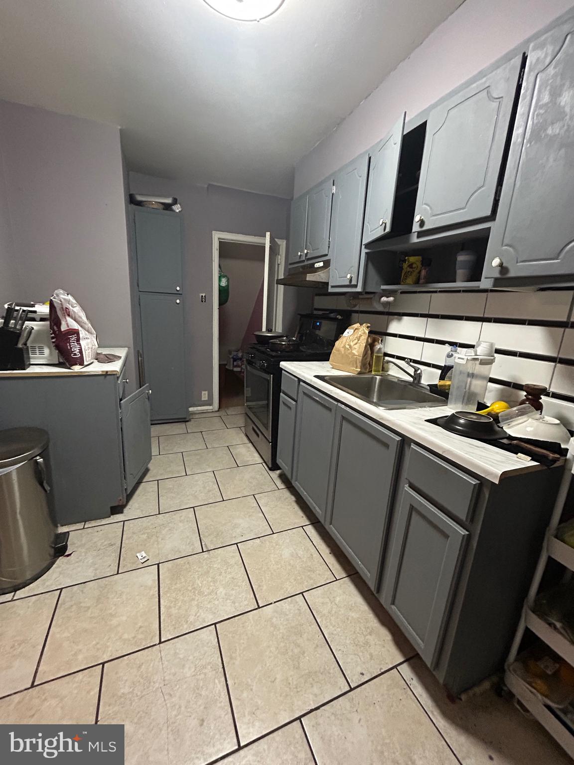 5331 Tabor Avenue Philadelphia, PA 19120 - Photo 15 of 18 a kitchen with stainless steel appliances a sink a stove top oven and cabinets