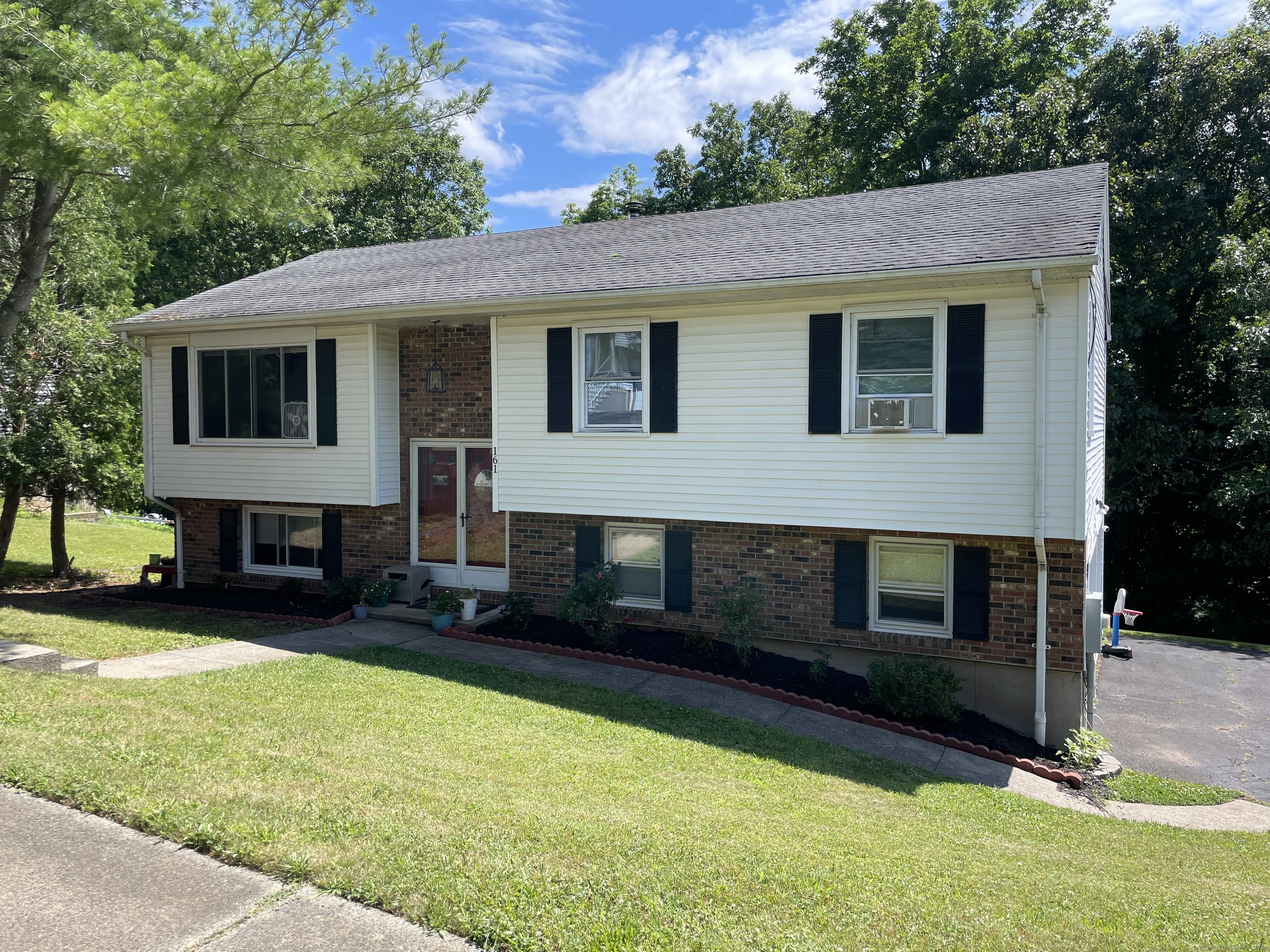 161 Cimarron Road Middletown, CT 06457 - Photo 1 of 1 a front view of a house with a yard