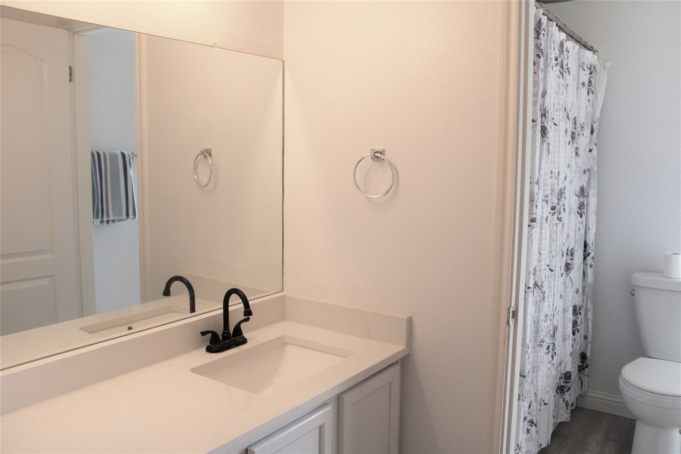 16205 Glorious Lane Pflugerville, TX 78660 - Photo 23 of 30 a bathroom with a sink toilet and shower