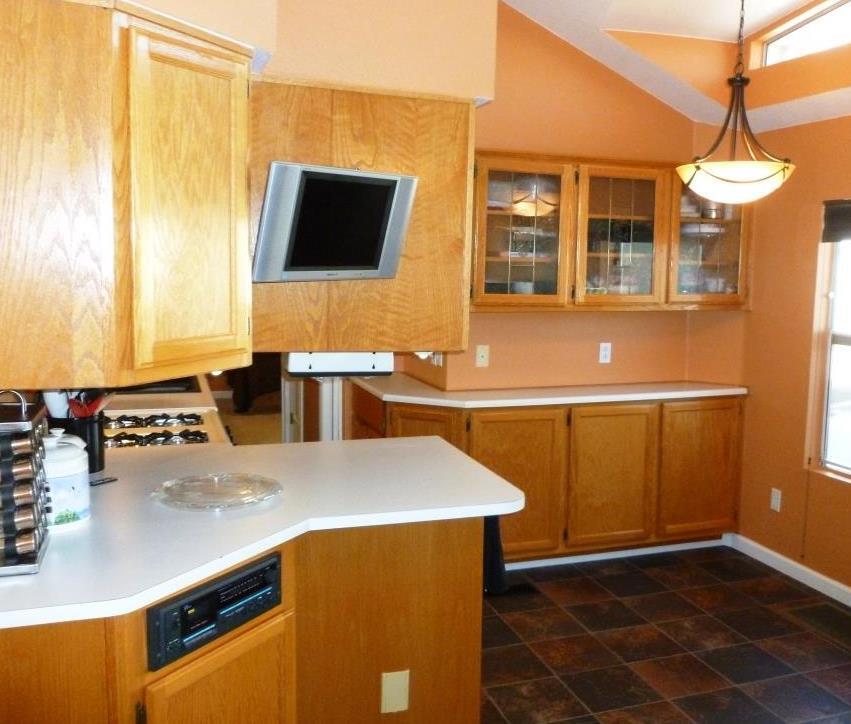 84136 Ave 44, Unit 58 Indio, CA 92203 - Photo 20 of 61 a kitchen with stainless steel appliances a stove a microwave a sink and cabinets