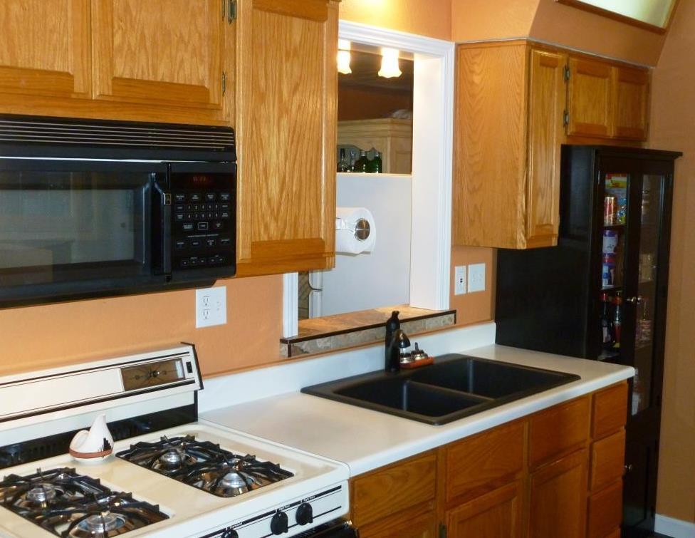 84136 Ave 44, Unit 58 Indio, CA 92203 - Photo 23 of 61 a kitchen with a sink and a stove top oven