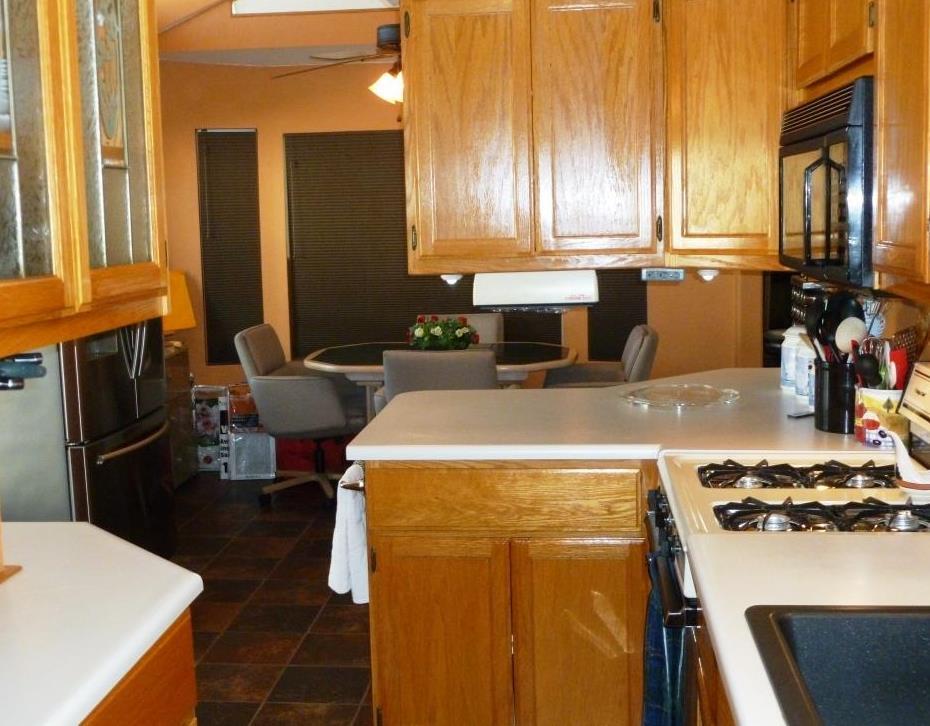 84136 Ave 44, Unit 58 Indio, CA 92203 - Photo 26 of 61 a kitchen with a stove and a refrigerator