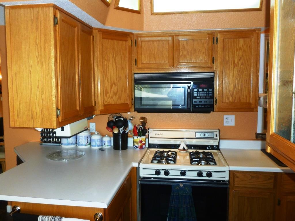 84136 Ave 44, Unit 58 Indio, CA 92203 - Photo 41 of 61 a kitchen with stainless steel appliances granite countertop a stove a sink and a microwave