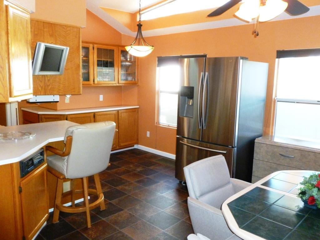 84136 Ave 44, Unit 58 Indio, CA 92203 - Photo 42 of 61 a living room with furniture a window and kitchen view