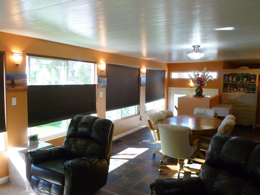 84136 Ave 44, Unit 58 Indio, CA 92203 - Photo 49 of 61 a living room with furniture a floor to ceiling window and wooden floor
