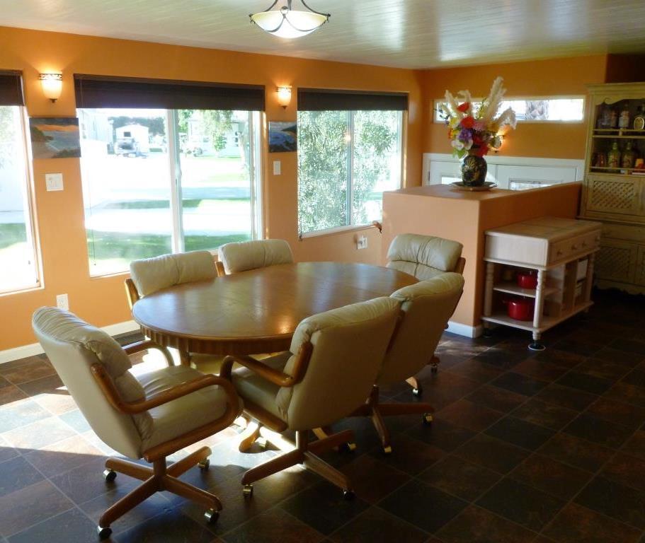 84136 Ave 44, Unit 58 Indio, CA 92203 - Photo 9 of 61 a living room with furniture and a floor to ceiling window