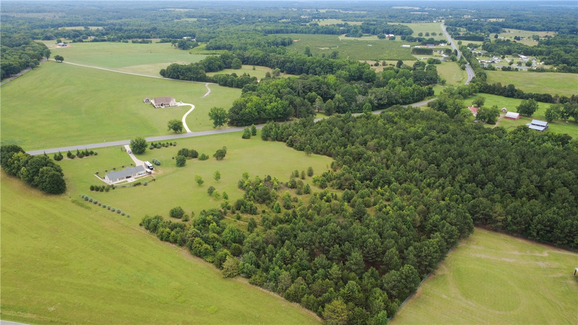 2900 Highway 187 Anderson, SC 29626 - Photo 35 of 41 Sprawling acreage with a private residence set against a backdrop of mature trees and open fields.