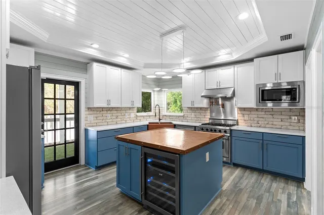 a kitchen with stainless steel appliances granite countertop a sink stove and cabinets