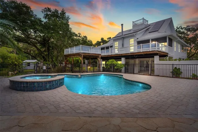 a view of a house with swimming pool and sitting area