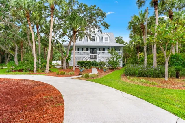 a front view of a house with a yard and fountain