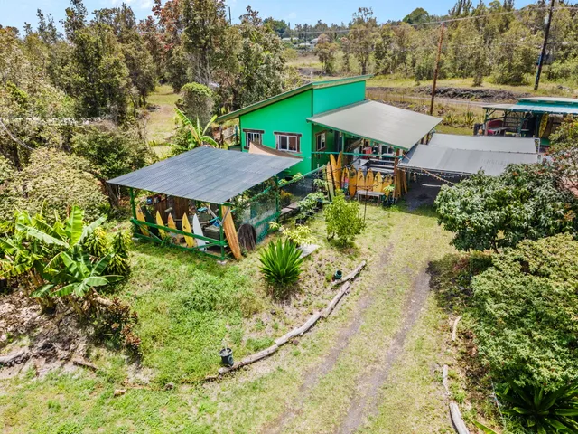an aerial view of a house with garden space and street view