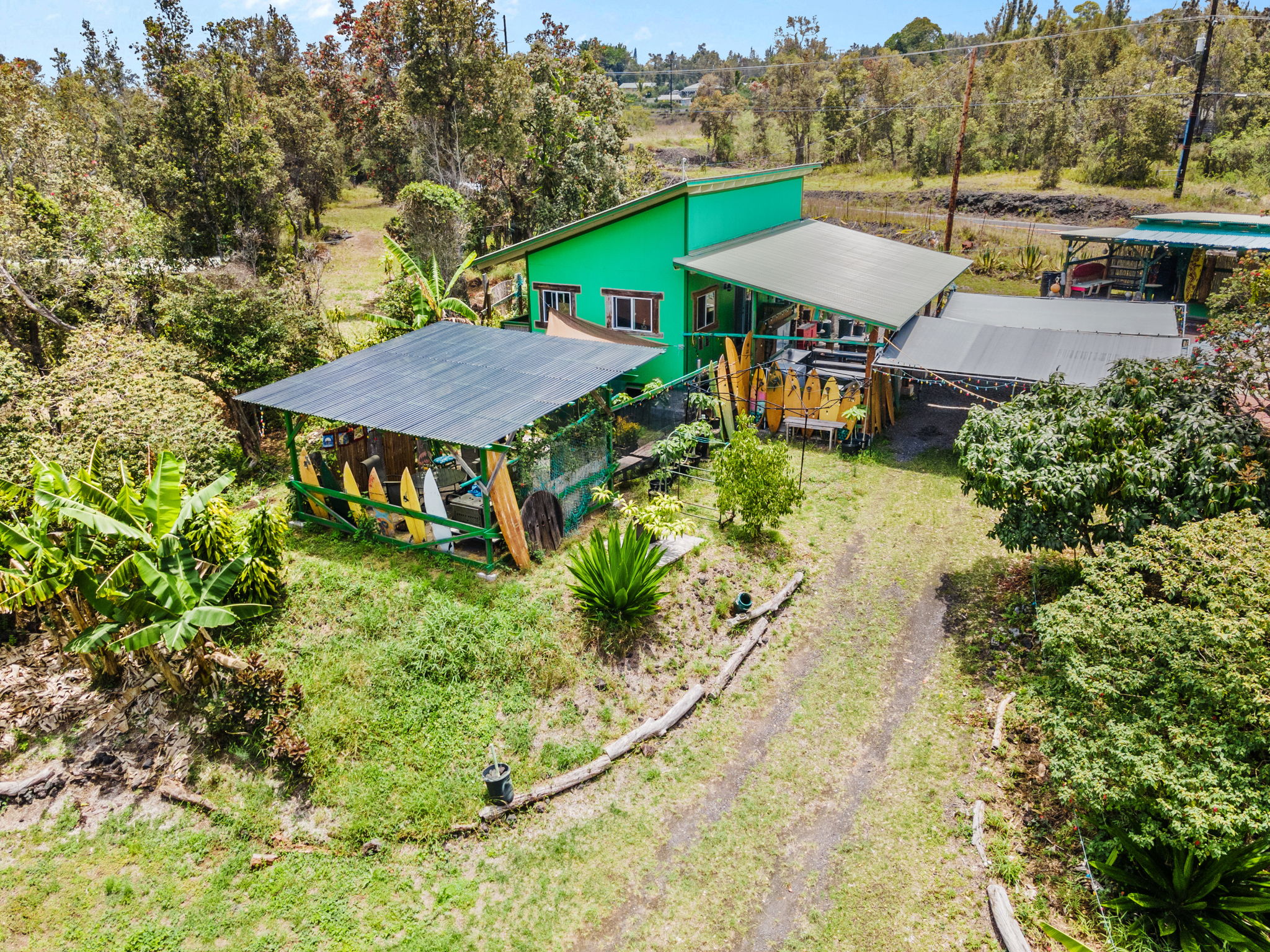 92-1347 Rd To The Sea Ocean View, HI 96704 - Photo 1 of 30 an aerial view of a house with garden space and street view
