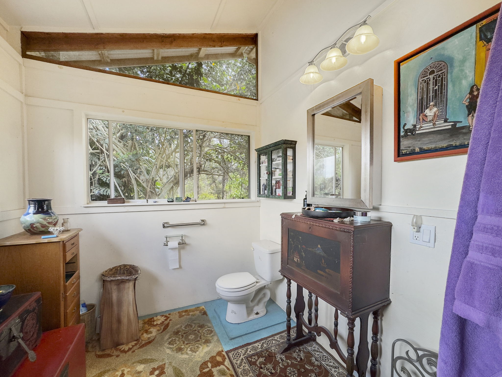 92-1347 Rd To The Sea Ocean View, HI 96704 - Photo 16 of 30 a living room with furniture and a large window