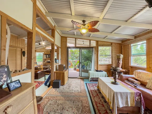 a living room with furniture a flat screen tv and a table