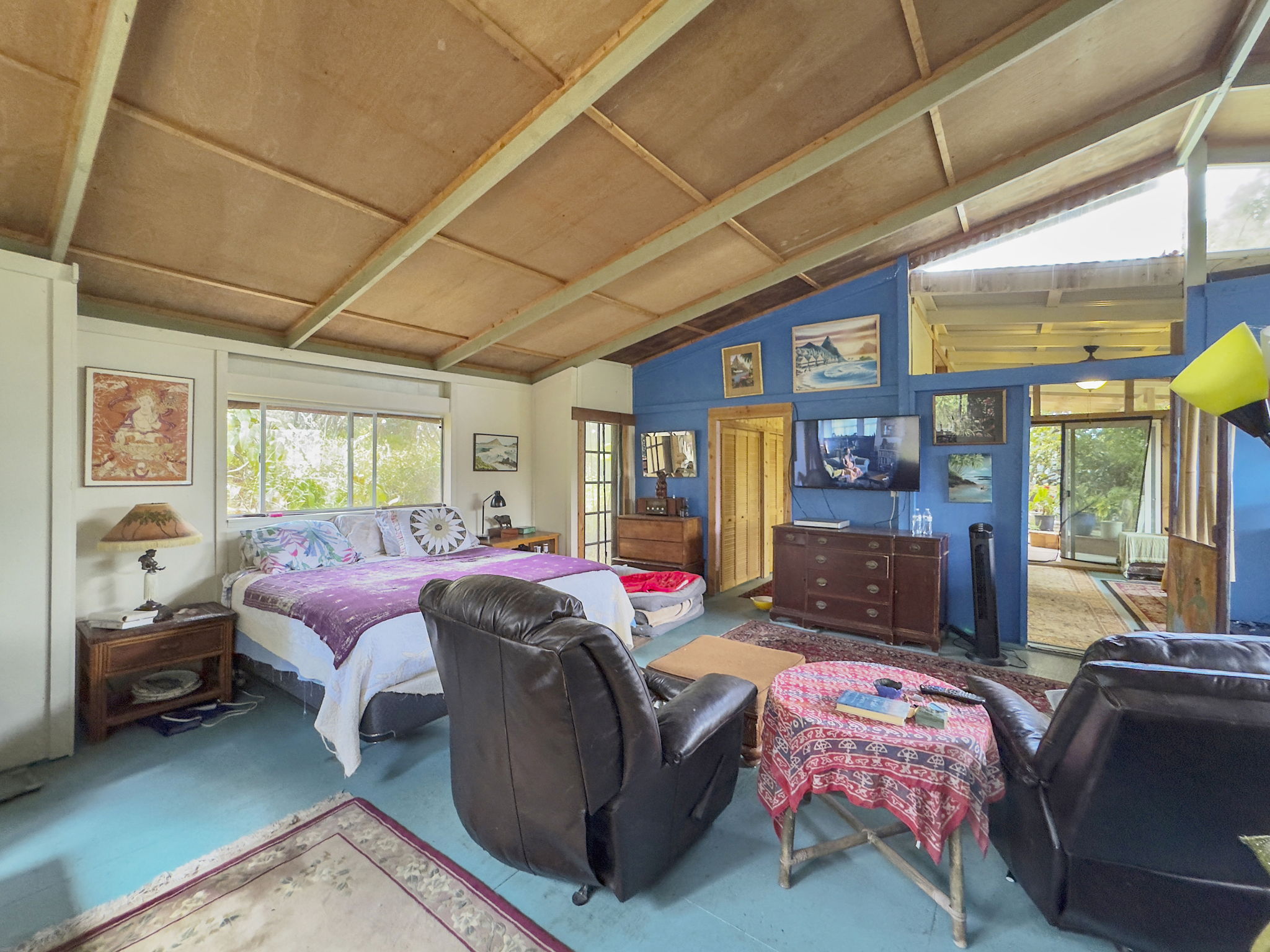 92-1347 Rd To The Sea Ocean View, HI 96704 - Photo 18 of 30 a bedroom with a bed and wooden floor