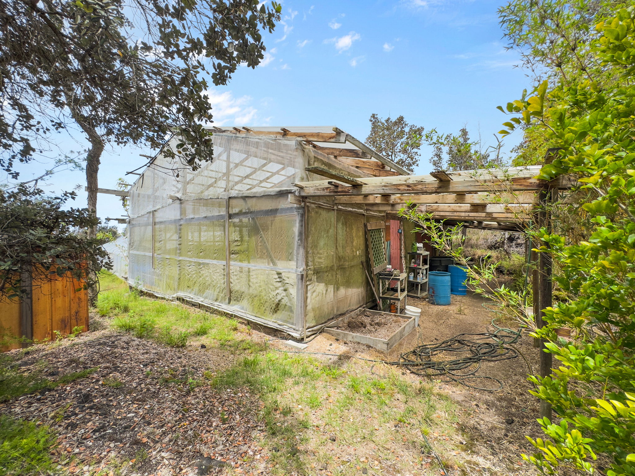 92-1347 Rd To The Sea Ocean View, HI 96704 - Photo 23 of 30 a view of a house with backyard and sitting area