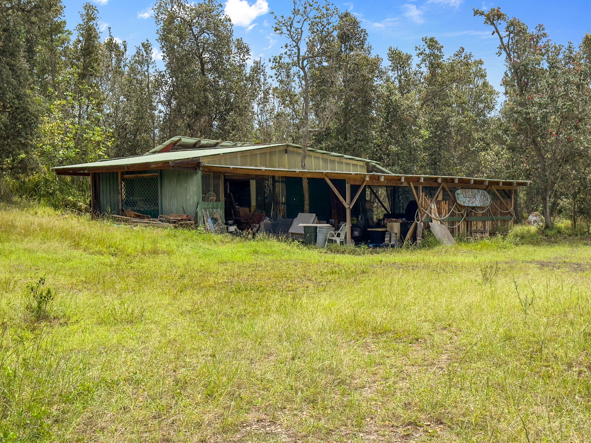 92-1347 Rd To The Sea Ocean View, HI 96704 - Photo 28 of 30 a view of a house with floor to ceiling windows and a yard