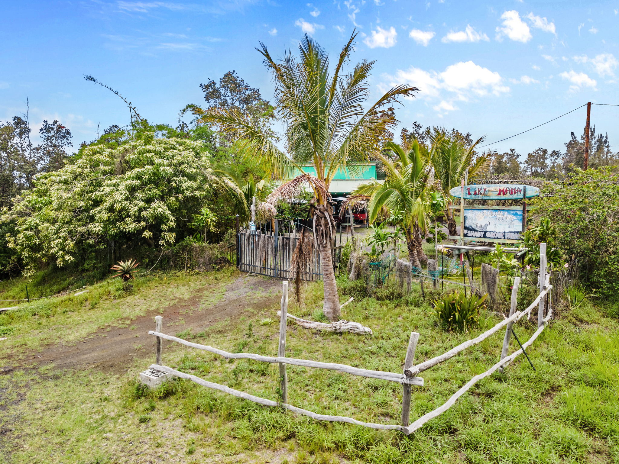 92-1347 Rd To The Sea Ocean View, HI 96704 - Photo 4 of 30 a view of a swimming pool with a bench and trees