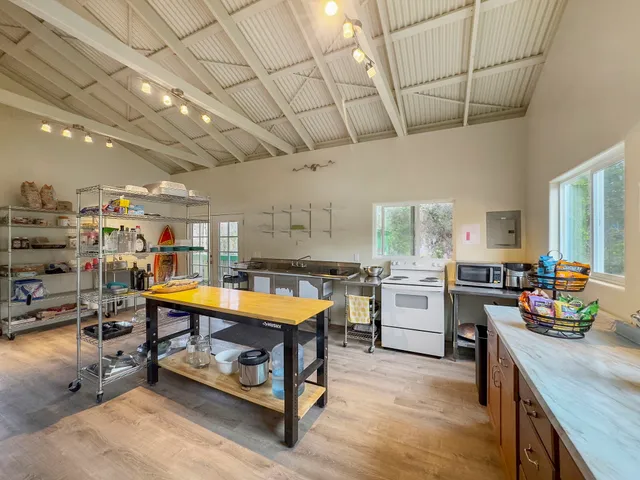a kitchen with lots of counter top space and a wooden floor