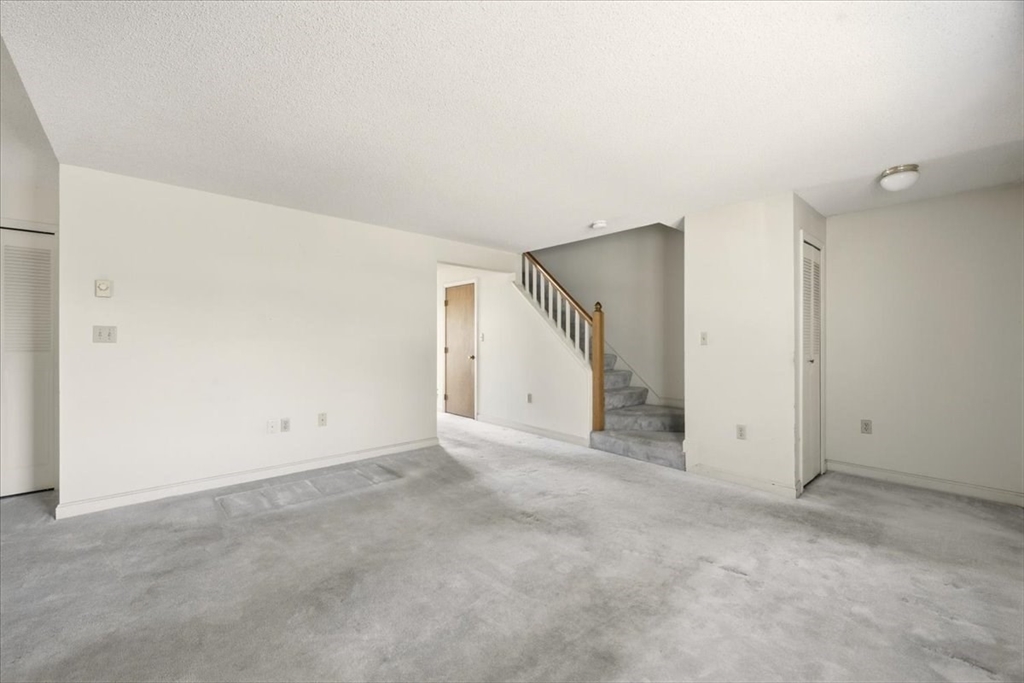 87 Victoria Heights Road, Unit 87 Boston, MA 02136 - Photo 5 of 32 an empty room with an entryway and closet area
