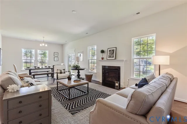 a living room with furniture fireplace and window