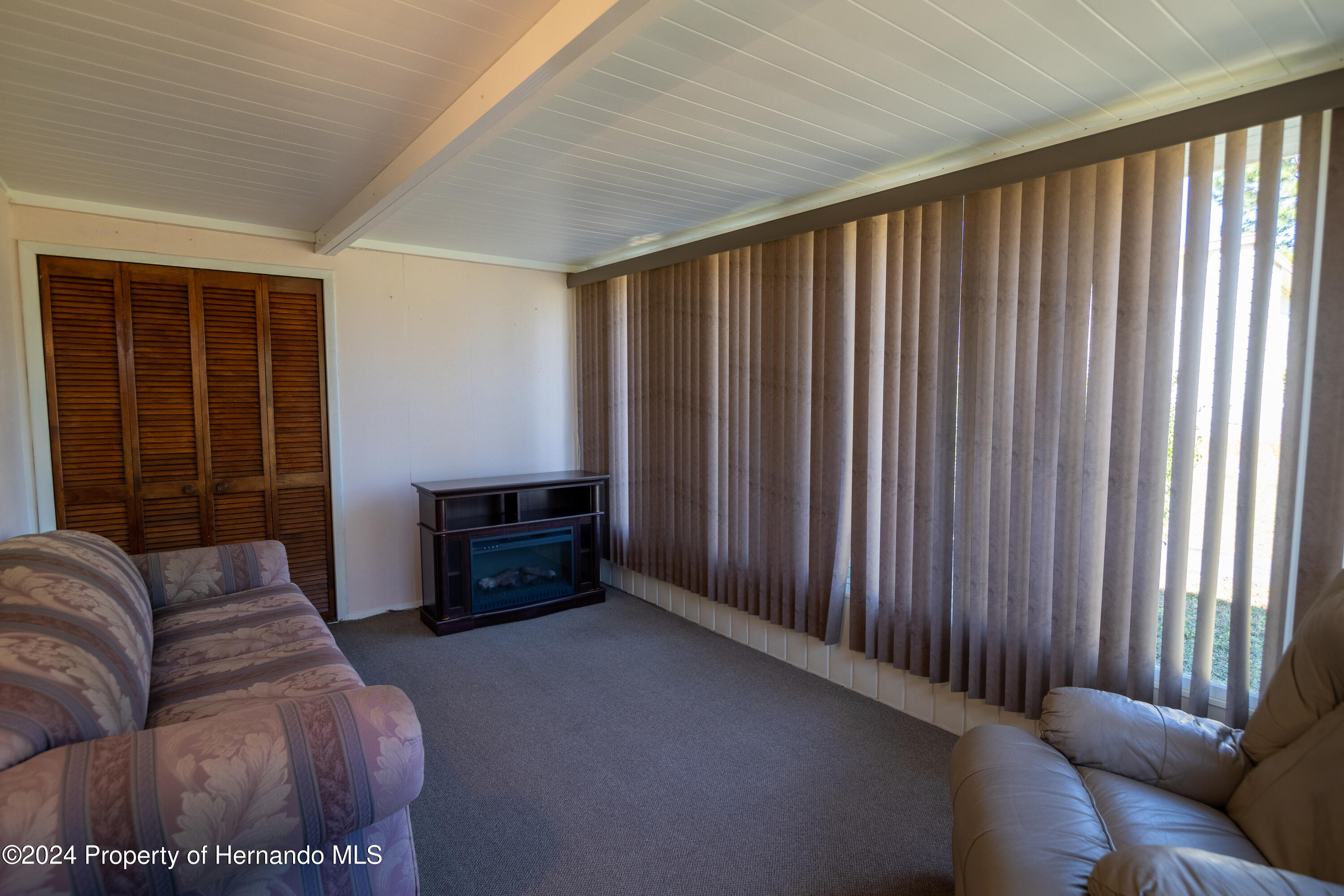 7526 Highpoint Boulevard Brooksville, FL 34613 - Photo 12 of 30 a living room with furniture and a window