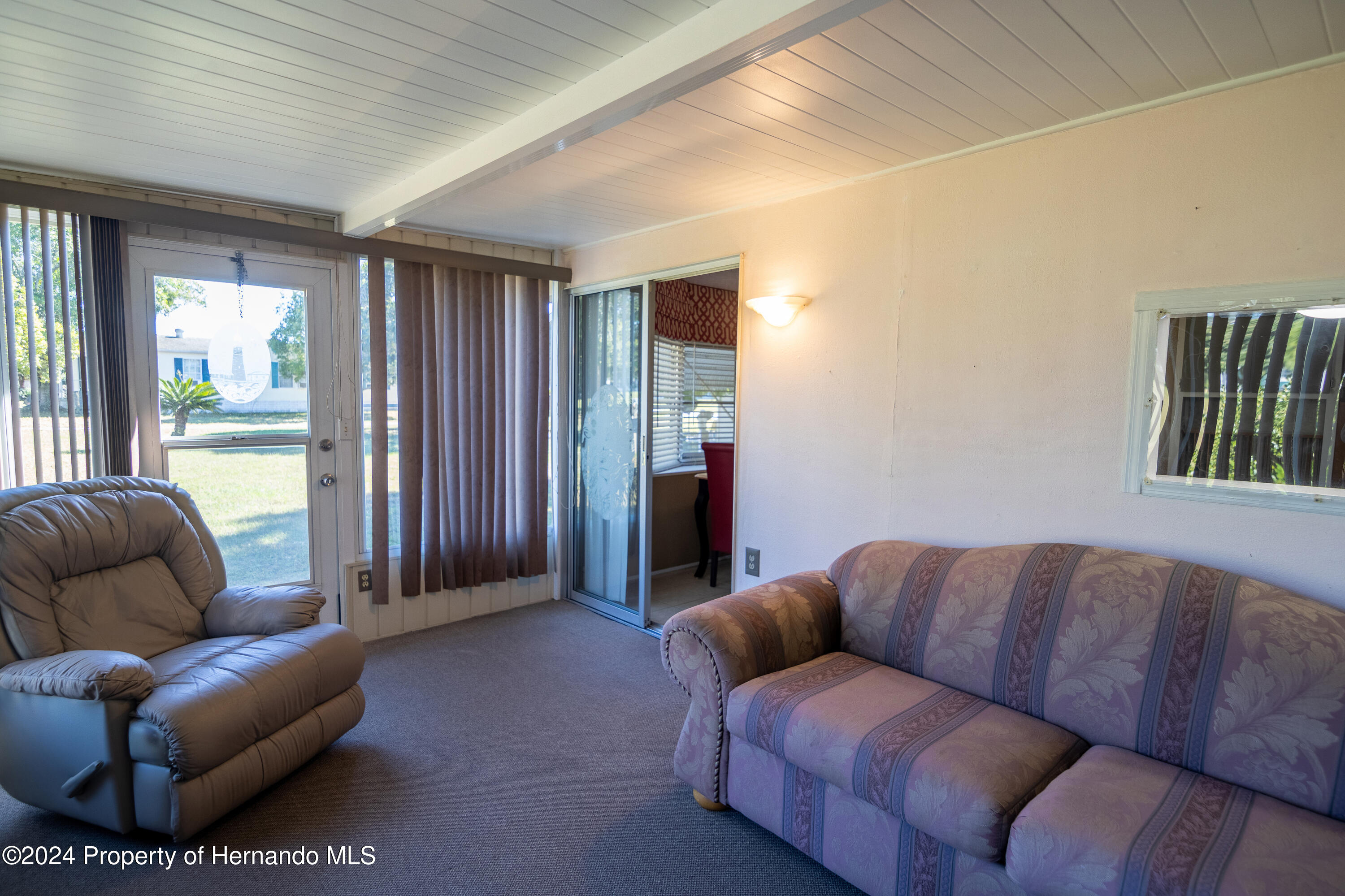 7526 Highpoint Boulevard Brooksville, FL 34613 - Photo 13 of 30 a living room with furniture and a large window