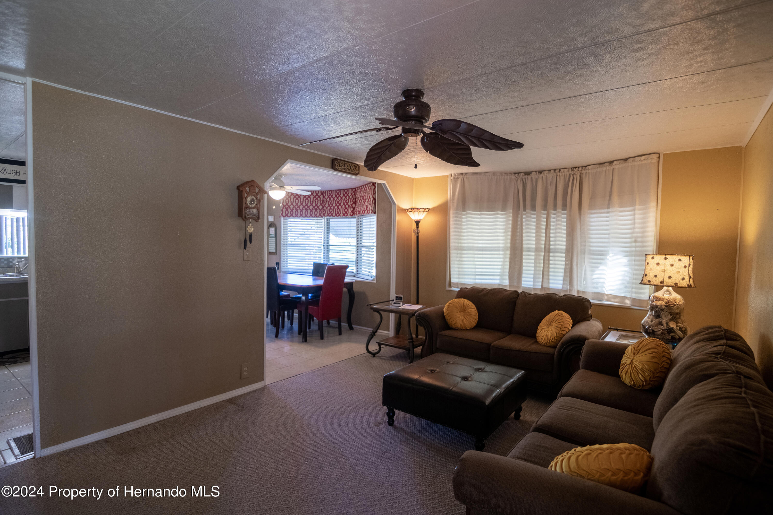 7526 Highpoint Boulevard Brooksville, FL 34613 - Photo 14 of 30 a living room with furniture and a large window